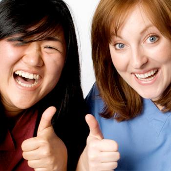 Two women giving thumbs up